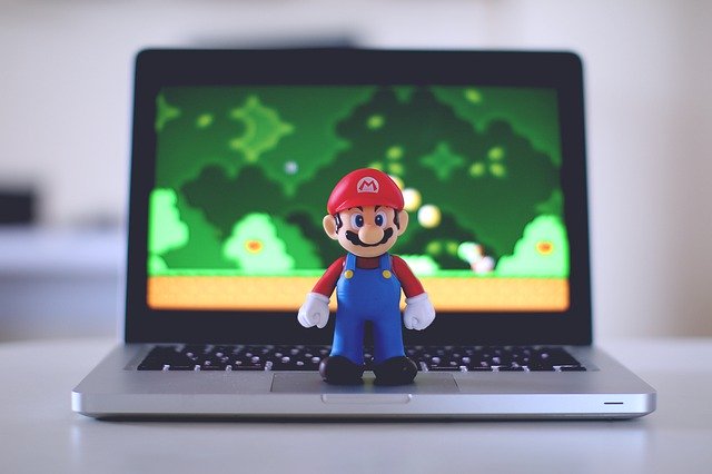 GamerMine Review. Super Mario standing on a laptop.